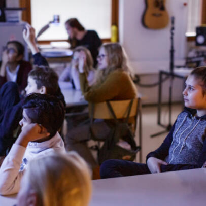 Children are watching educational videos together in a classroom.